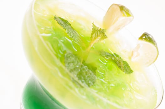 Citrus Paradise Cocktail made from Midori Melon, White Rum, pineapple, lime juice and garnishes with lime slice and fresh mints leaves