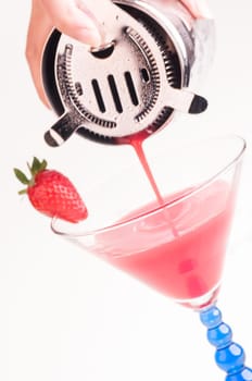 Pouring a Strawberry Daiquiri into a cocktail glass