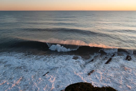 wave and wind at sunset in Genoa