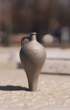 Fountain in jug shape on foreground in Yerevan, Armenia.