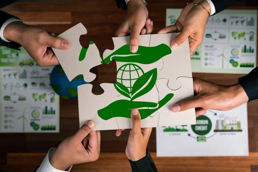 Top view cohesive group of business people forming jigsaw puzzle pieces in environmental awareness symbol as eco corporate responsibility as sustainable solution for greener Earth. Quaint