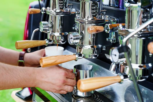 Barista Making Tasty Coffee on a Professional Machine Installed in the Backside of a Minivan: Food Service, Best Coffee, and Events Outdoors