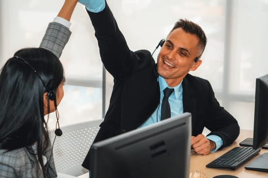 Business people wearing headset celebrate working in office . Call center, telemarketing, customer support agent provide service on telephone video conference call. Jivy