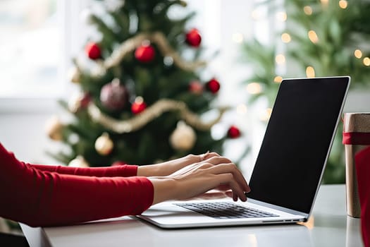 a woman working on her laptop in front of a christmas tree with presents and gifts around the window behind it