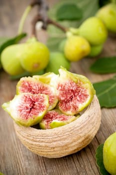 Delicious fresh white figs in bowl on wooden backgroud
