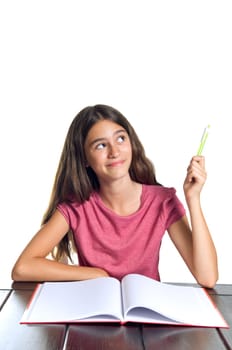 Schoolgirl pointing up with green pen. Isolated on white.