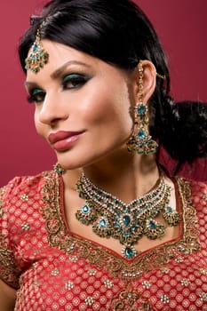 beautiful indian woman wearing bridal outfit on red
