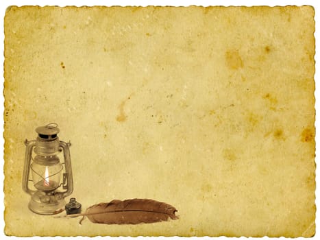 Old oil lamp and quill on old paper