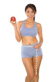pretty asian woman measuring her waist line