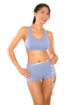 pretty asian woman measuring her waist line