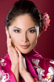 pretty asian woman wearing kimono on red background