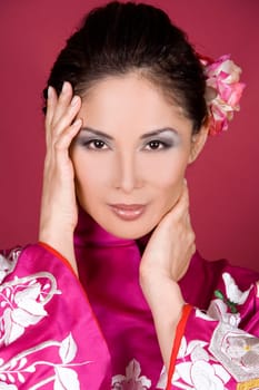 pretty asian woman wearing kimono on red background