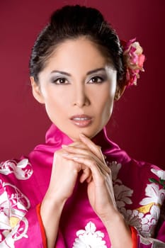 pretty asian woman wearing kimono on red background