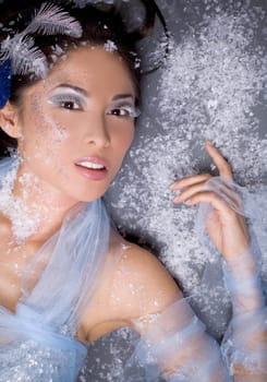 pretty brunette woman wearing white and silver accessories