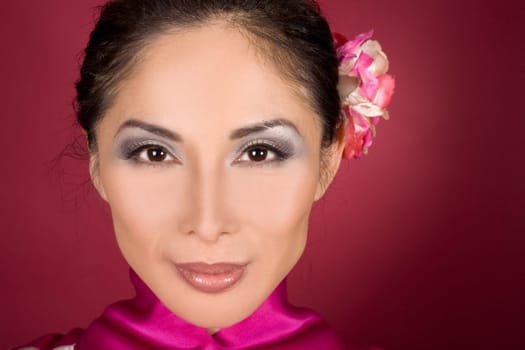 pretty asian woman wearing kimono on red background
