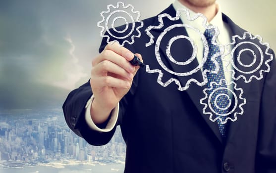 Businessman with gears - concepts of teamwork, efficiency, interlocking parts.