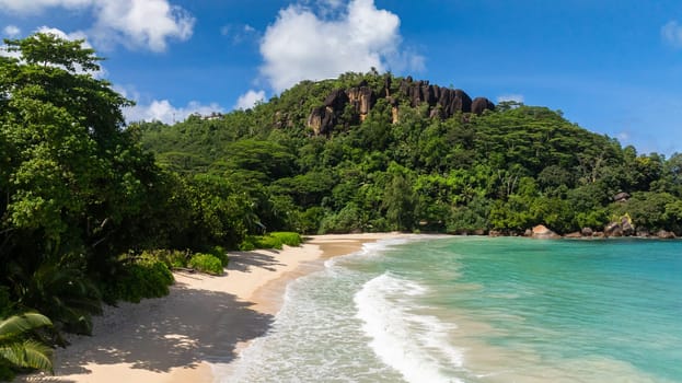 Bay with soft waves lapping on a sandy beach. Anse Louis. Seychelles, Mahe.
