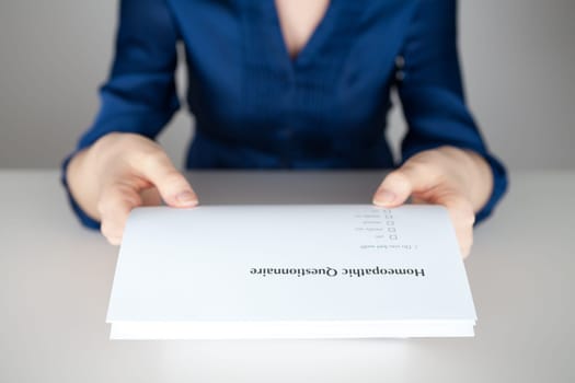 Homeopathic questionnaire concept - woman give you a questionnaire.