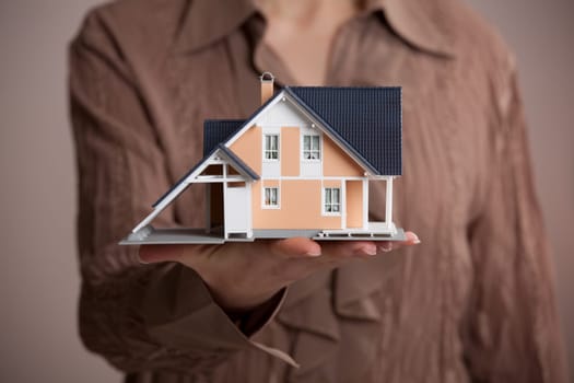 Real estate agent offer house represented by model.