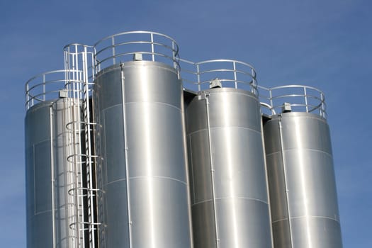 View of an industrial plant with large aluminium tanks