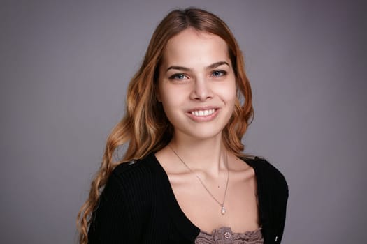 Happy young woman portrait, smiling at camera.