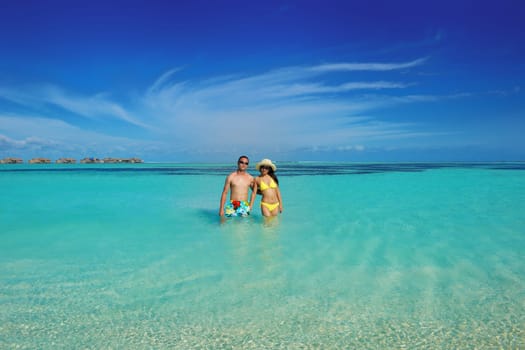 happy young asian couple enjoying summer and have on beautiful white sand beach