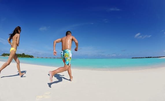 happy young asian couple enjoying summer and have on beautiful white sand beach