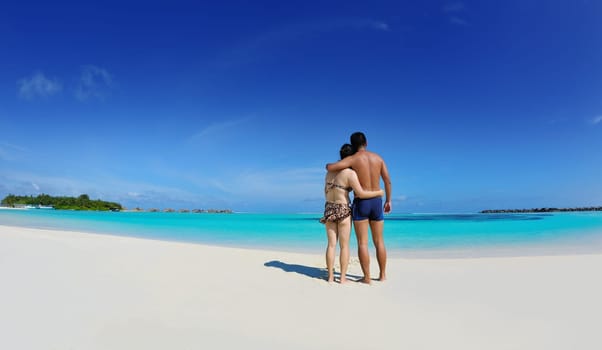 happy young asian couple enjoying summer and have on beautiful white sand beach