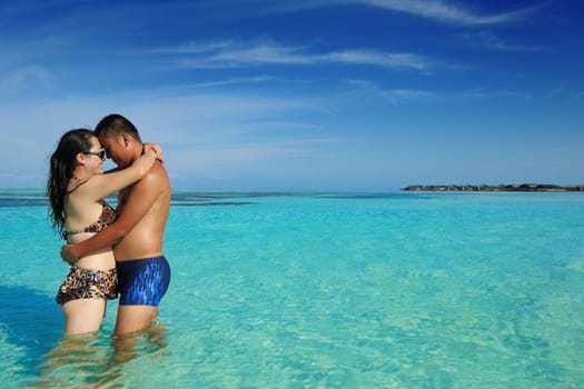 happy young asian couple enjoying summer and have on beautiful white sand beach