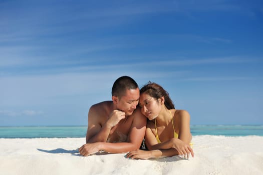 happy young asian couple enjoying summer and have on beautiful white sand beach