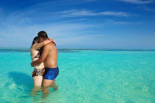 happy young asian couple enjoying summer and have on beautiful white sand beach