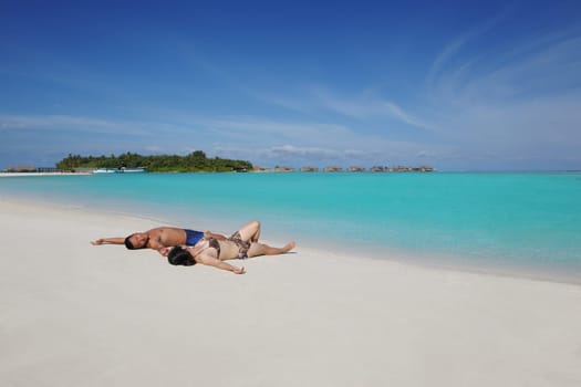 happy young asian couple enjoying summer and have on beautiful white sand beach