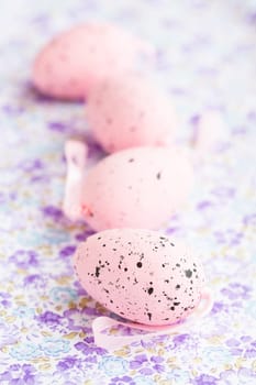 Closeup of pink Easter eggs on patterned surface