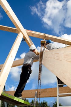 carpenter or construction worker at work with wooden  roof construction