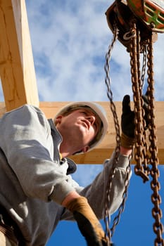 carpenter or construction worker at work with wooden  roof construction