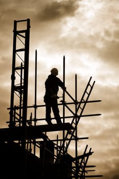 carpenter or construction worker at work with wooden  roof construction