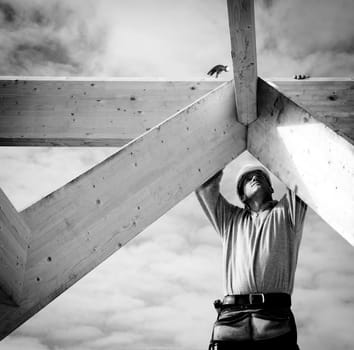 carpenter or construction worker at work with wooden  roof construction