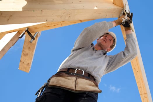 carpenter at work with wooden  roof construction