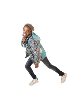 A young pretty black girl in jeans and a blue jacket dancing for white background in the studio.