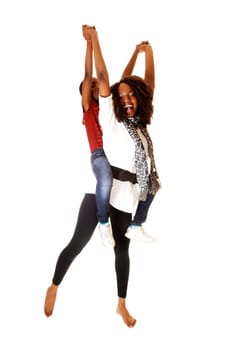 Two black sisters playing with each other, the small one sitting on the back of the older one, for white background.