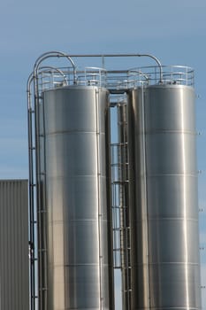 View of an industrial plant with large aluminium tanks