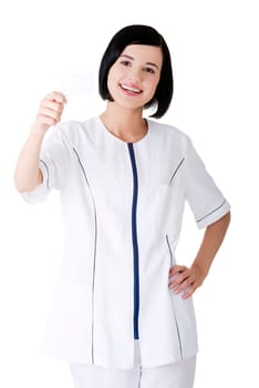 Woman doctor or nurse holding blank business card in her hand