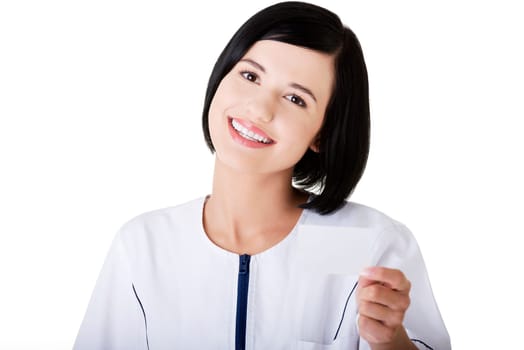 Woman doctor or nurse holding business card in her hand