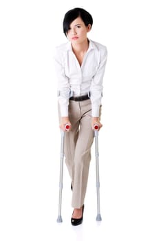 Young businesswoman with crutches, isolated on white. Disabled person in work.