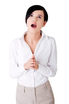 Shocked businesswoman looking up, isolated on white