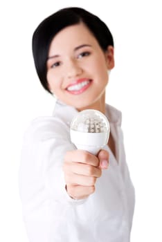 Businesswoman showing eco led bulb, isolated on white