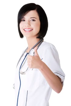 Young female doctor or nurse gesturing OK , isolated