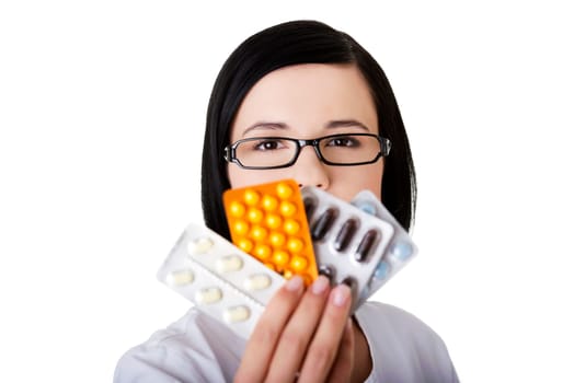 Portrait of beautiful doctor or nurse holding prescription drugs isolated over white background