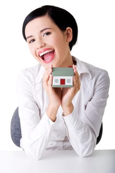 Female businesswoman hands holding and protecting house. Home protecting concept for insurance or security
