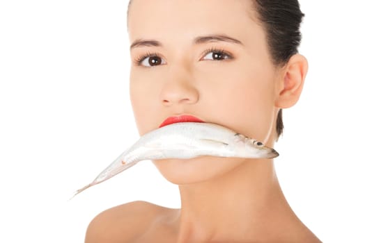 Beautiful young woman with fish in her mouth